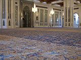 Muscat 04 Grand Mosque 06 Large Persian Carpet The main prayer hall has the largest carpet in the world, a 70m x 60m Persian carpet that took 600 women four years to weave. On the back wall is the mihrab, a niche in the wall facing Mecca. To the right of the mihrab is the minbar, a pulpit chair dating from the Prophet Mohammeds time. The `imam', the one who leads the prayer, delivers the `khutba', the Friday sermon, which can deal with religious, social and political subjects.